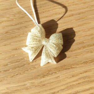 Nœud du bonheur blanc paillettes dorées